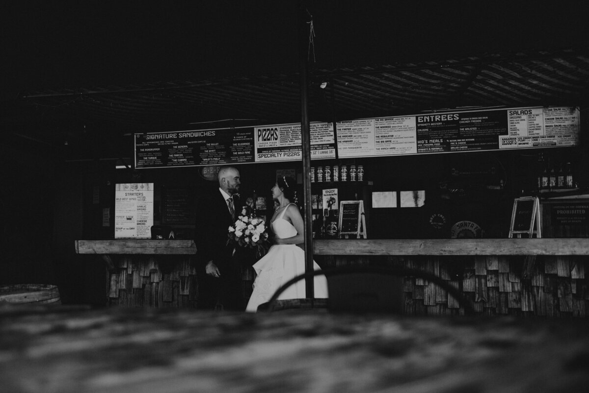 bride and groom standing together at a brewery in Santa Fe