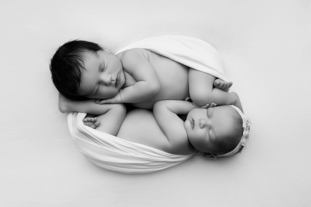 New Jersey's best newborn photographer, Katie Marhsall, captures twin newborn babies sleeping head-to-toe.