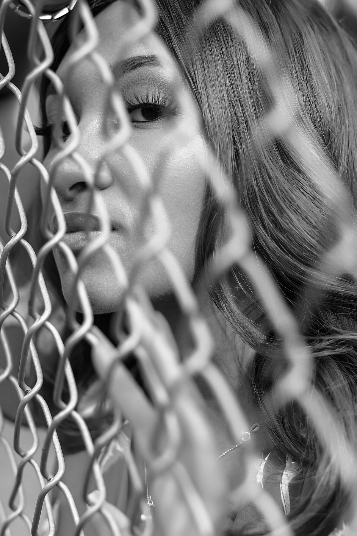 African American woman looking through a fence