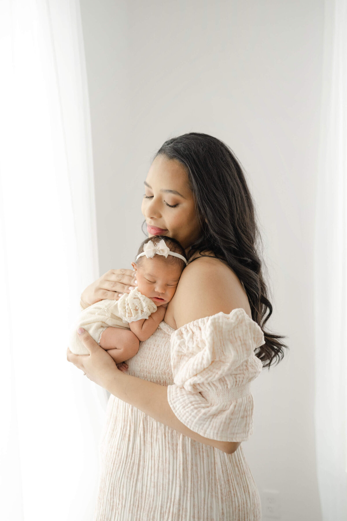 mother snuggles her newborn on her chest in a photography studio near downtown oklahoma city