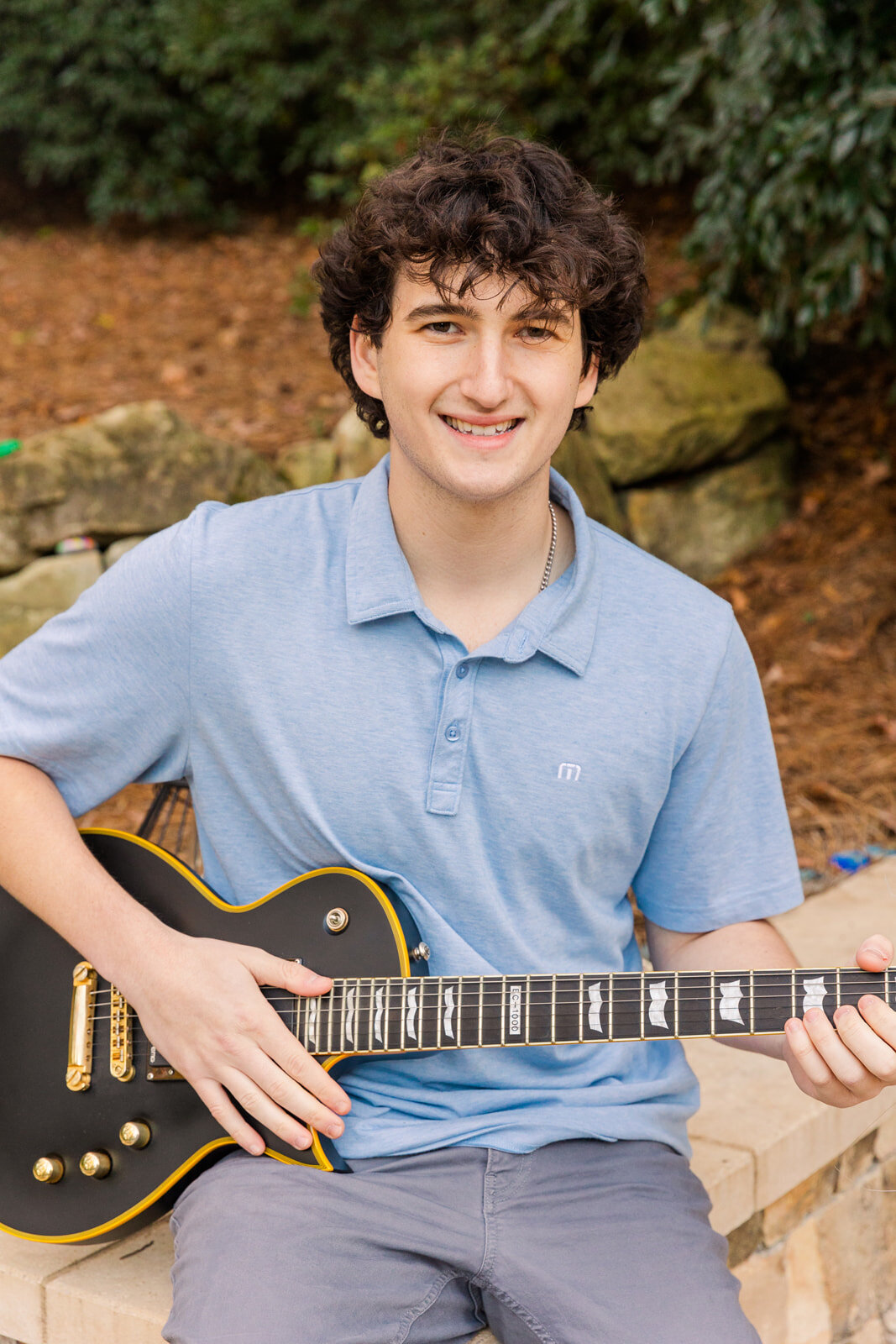 Boy playing the guitar during fall senior photo session Atlanta GA Laure Photography