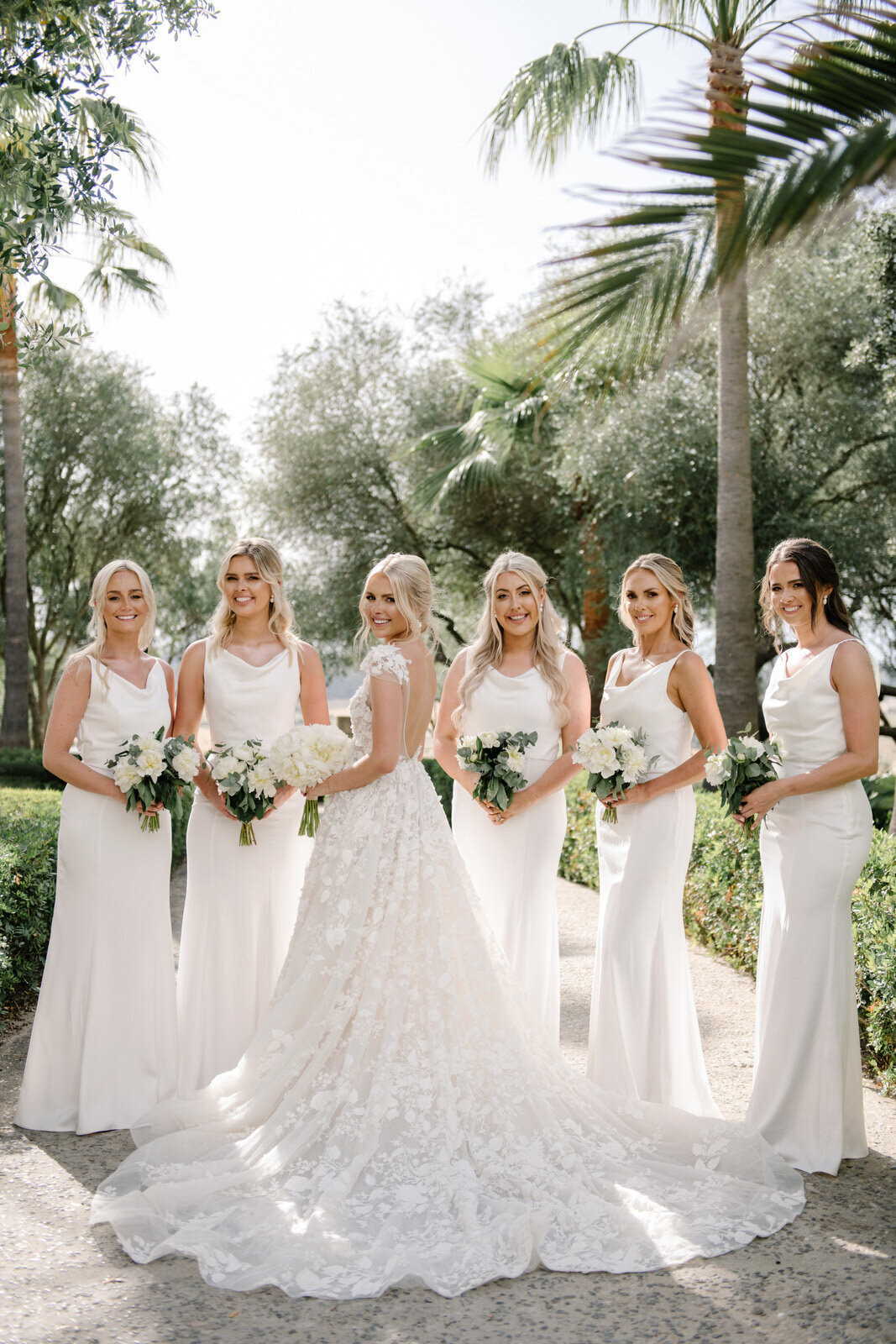 bride in muse by berta and bridesmaids in white dresses at mallorca wedding