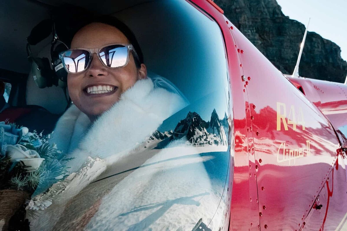 Luxury-Multi-Day-Alaska-Elopement-bride-in-helicopter-with-mountain-reflection-11