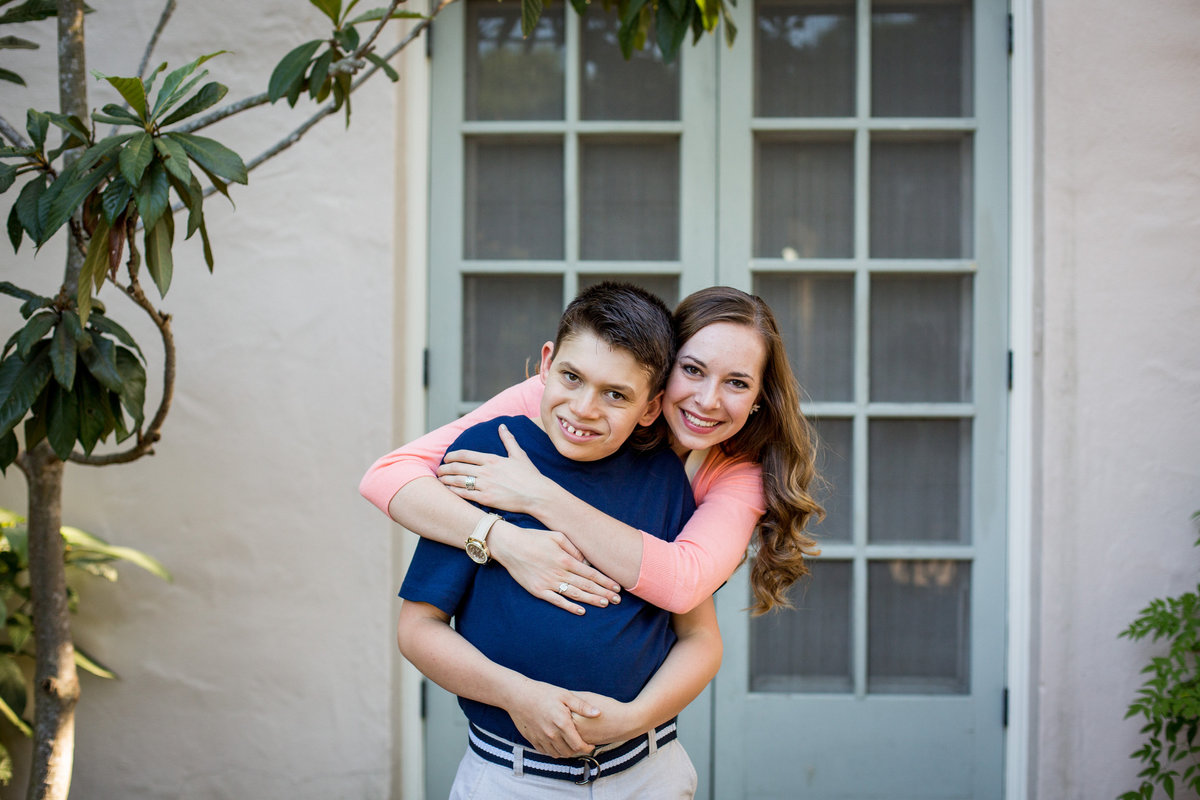 sister holding her brother and smiling for family portrait session by San Antonio photographer Expose The Heart