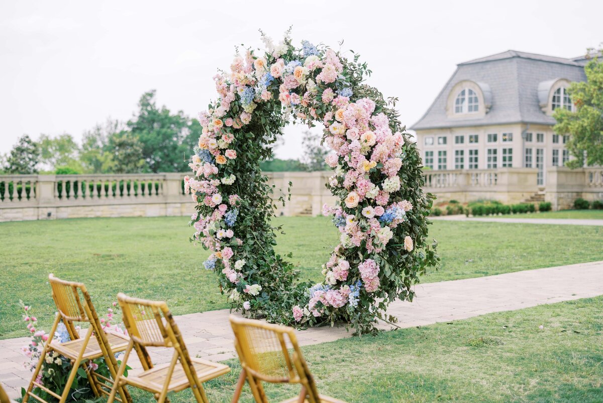 floral arch in front of the olana wedding venue