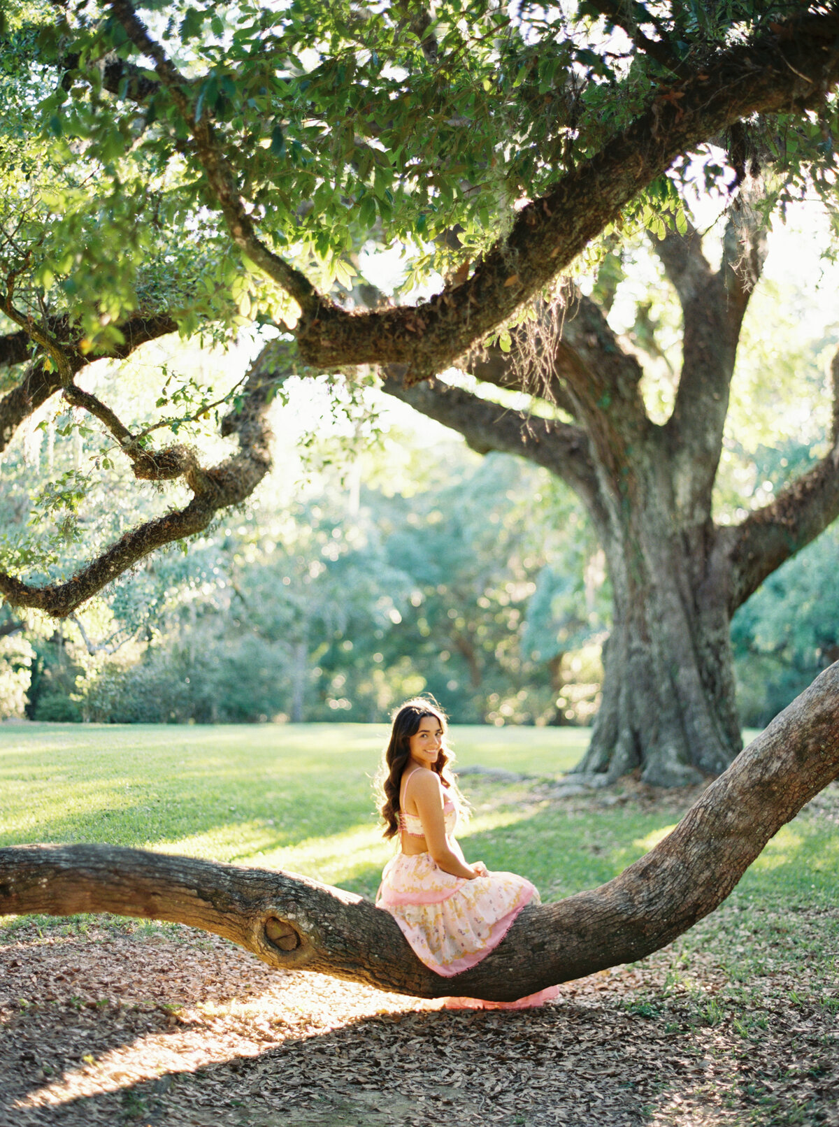 A stunning senior portrait set among the lush flowers and greenery of Jungle Gardens, captured with elegance and grace on film by Morgan Alysse, Louisiana film photographer.