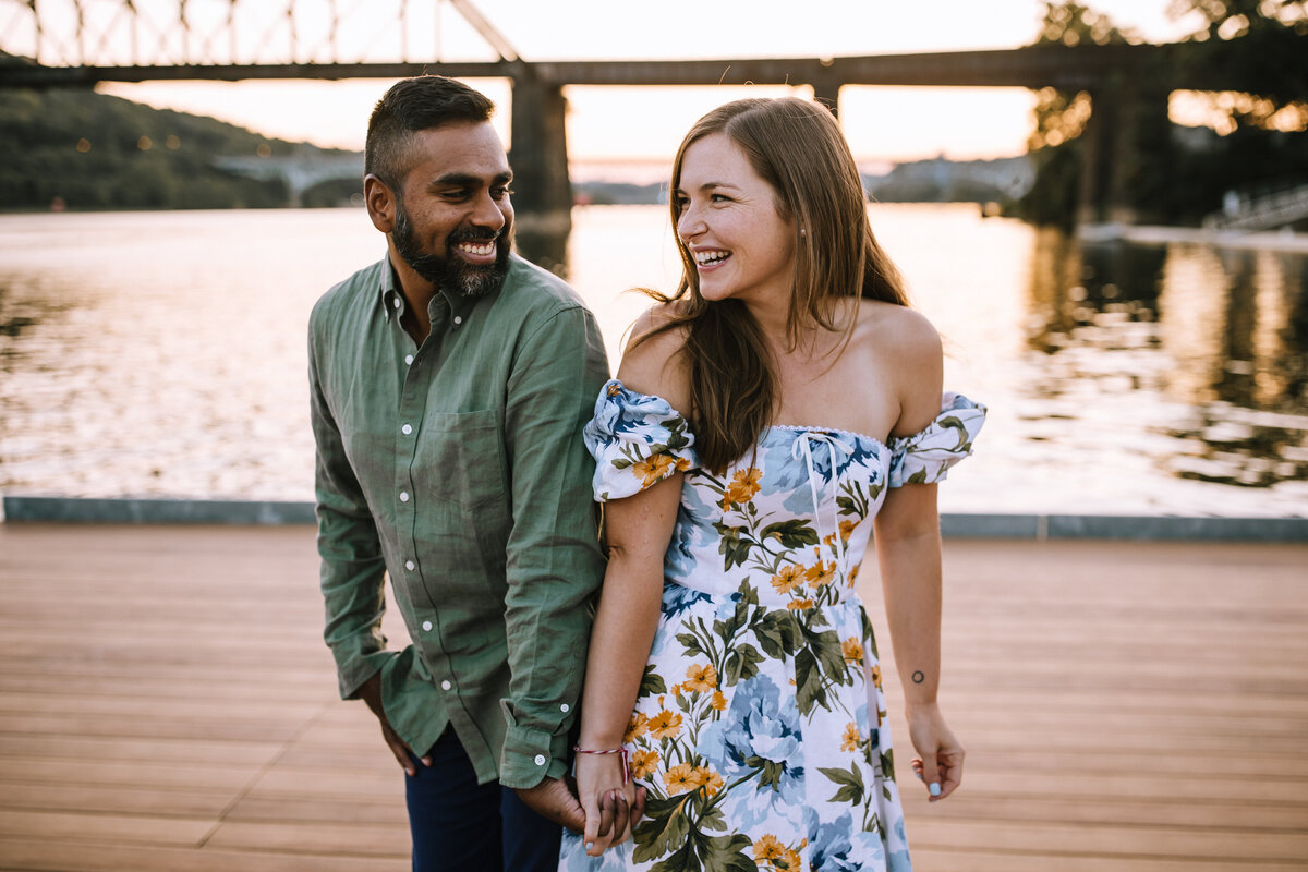 Engaged couple on a dock at the Aspinwall Riverfront.