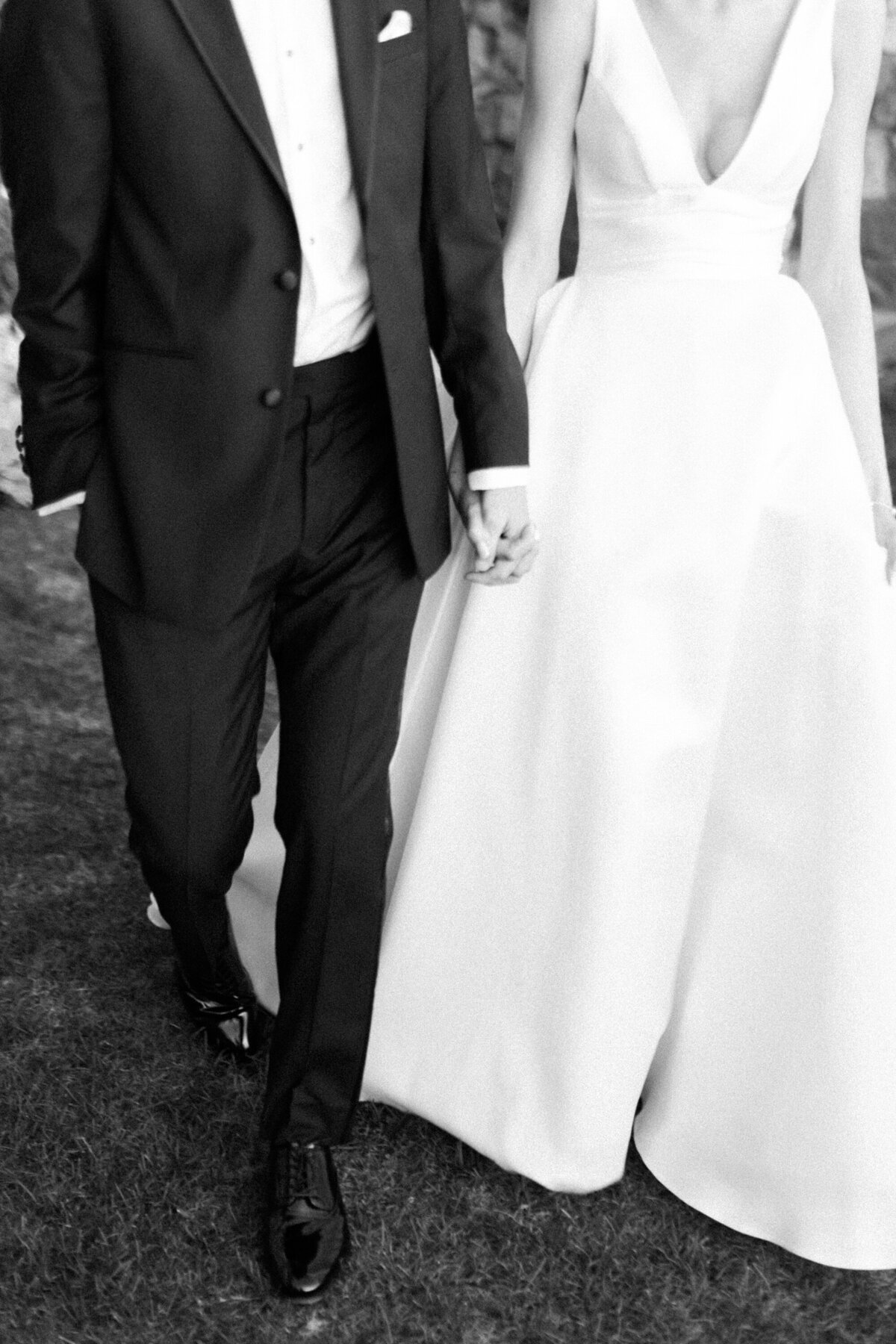 black and white of wedding couple holding hands