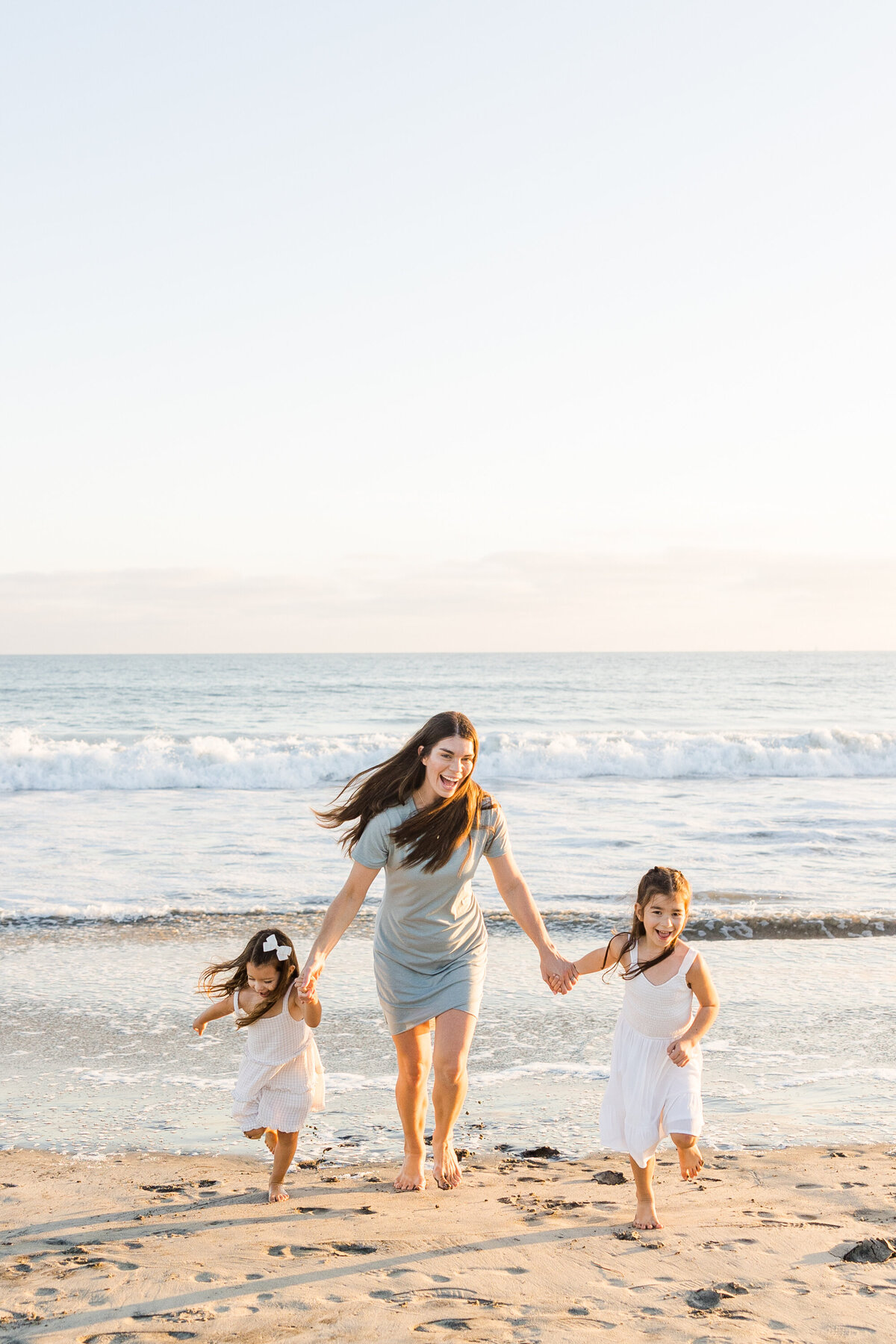 mother-and-daughters-running-on-coronado-beach-san-diego