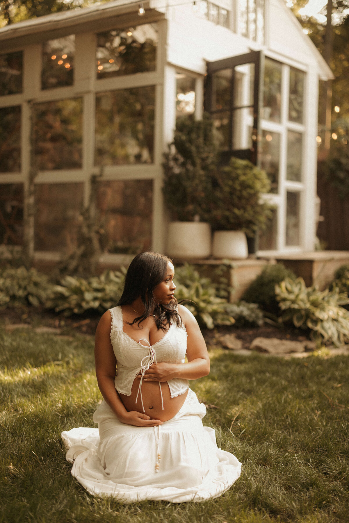 Pregnant woman walking through tall grass during Franklin Tennessee maternity session