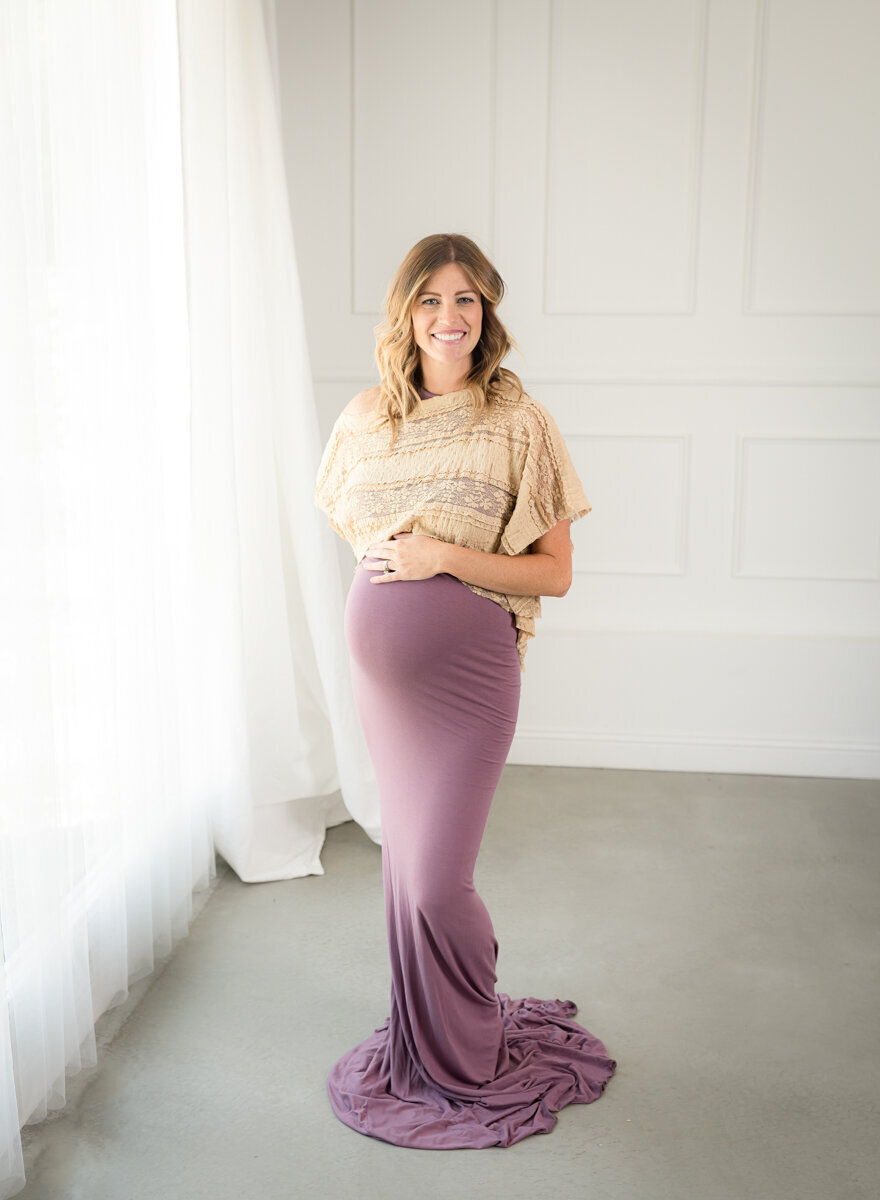 Studio maternity session with a purple boho gown.