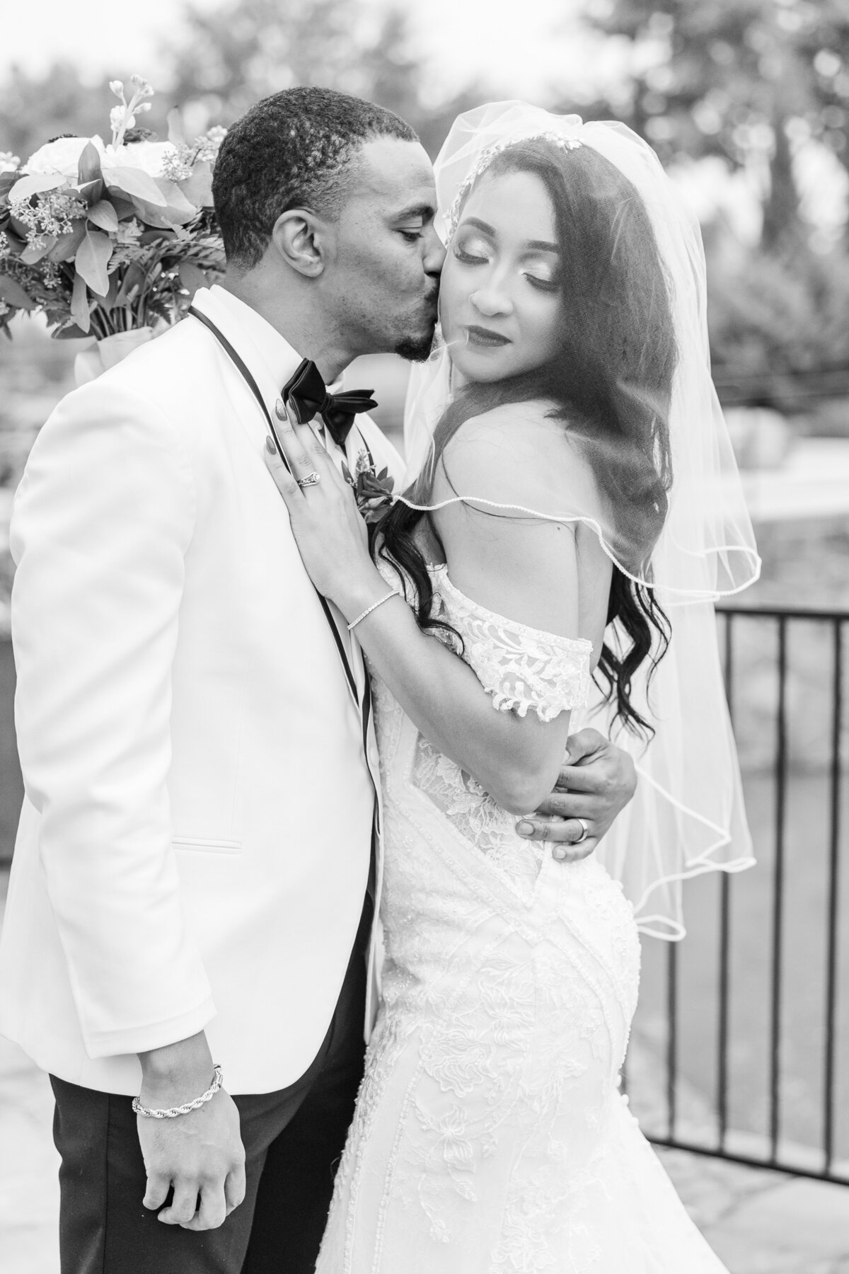 groom-kissing-bride-on-bridge-at-the-chapel-at-riverwalk-flower-mound-texas