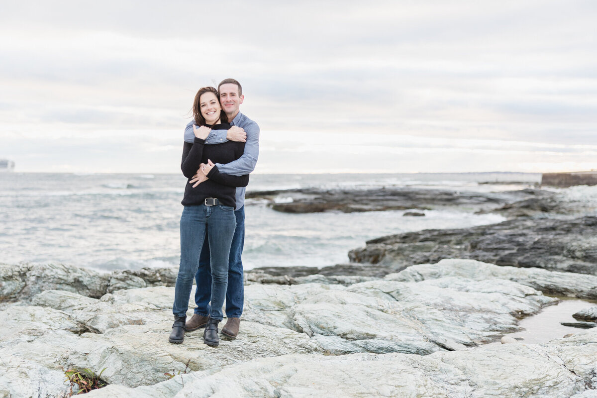 Couple embraces on the coast of Rhode Island