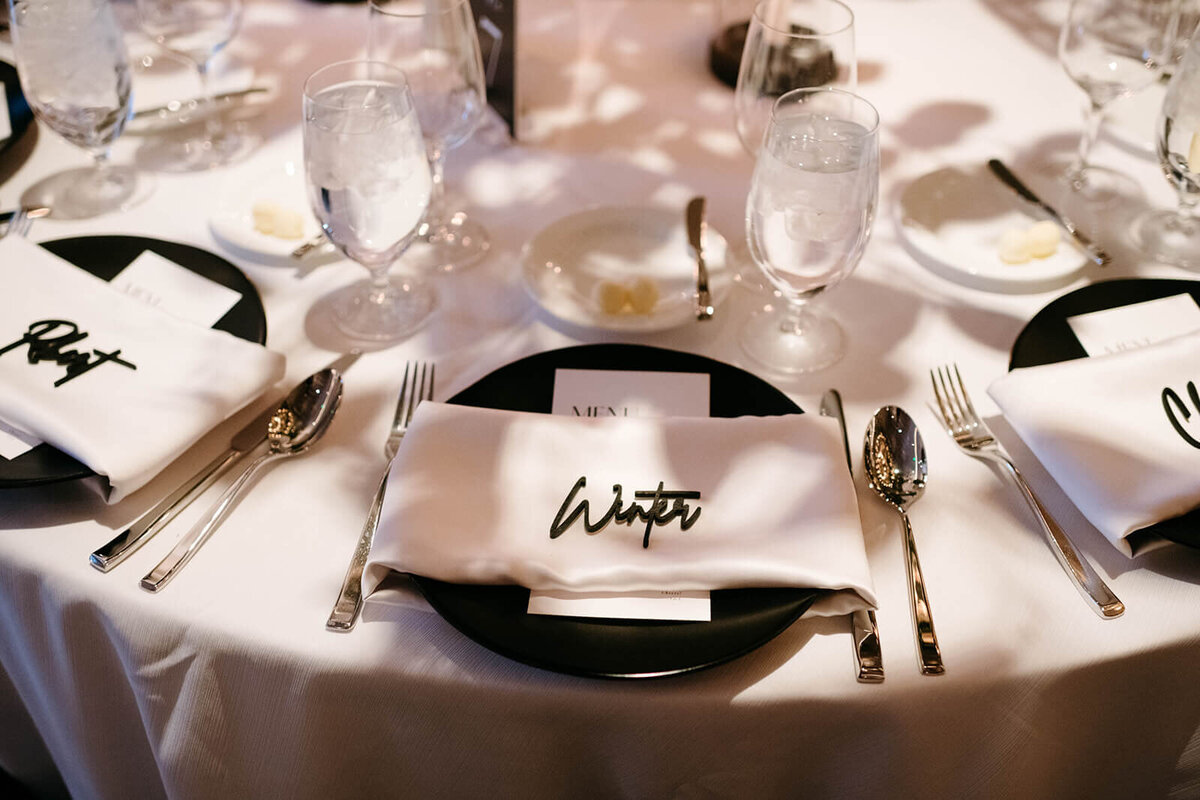 Wedding reception table at St. Regis Aspen, featuring soft candlelight, floral arrangements, and artistic shadow patterns.