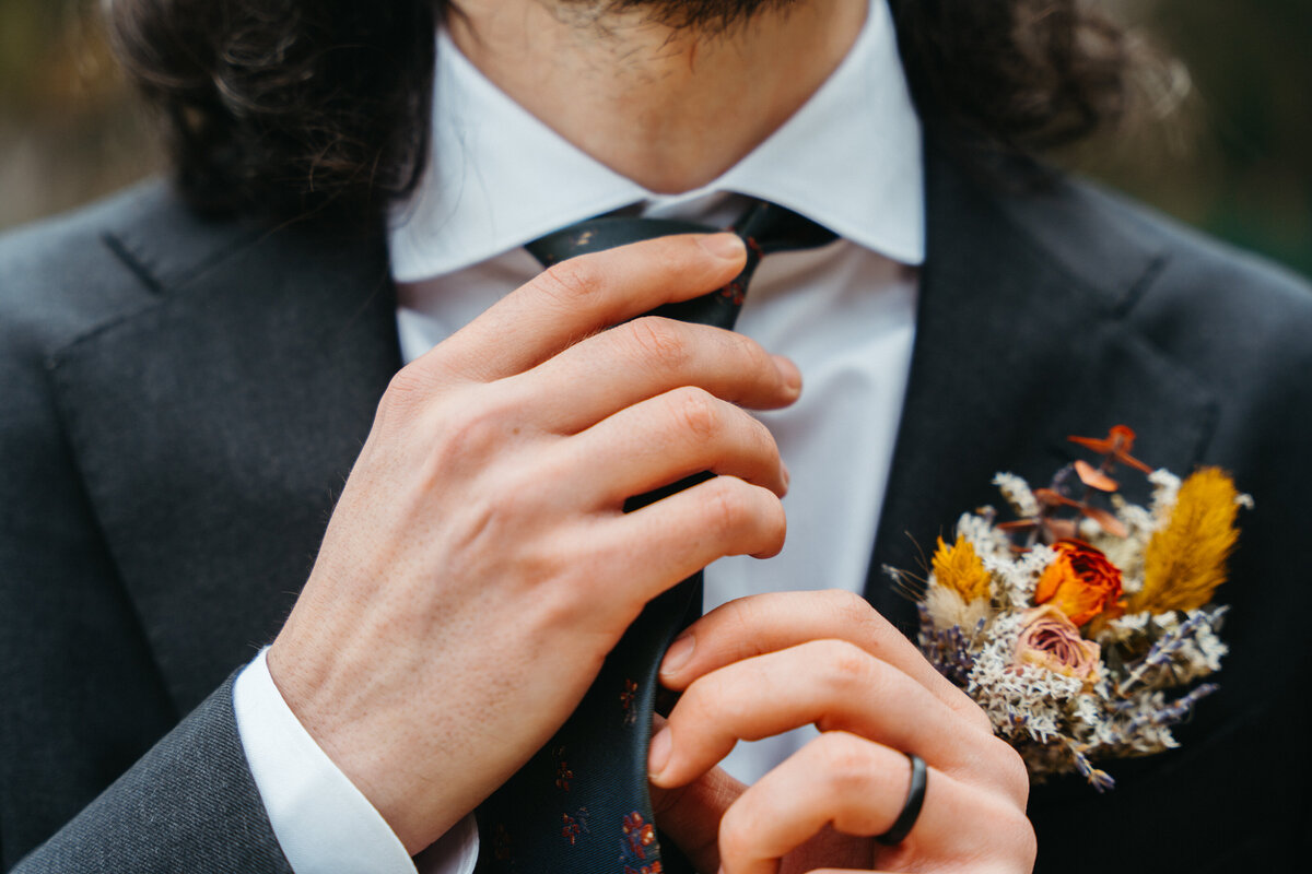 Groom adjusting tie before Dolomites wedding