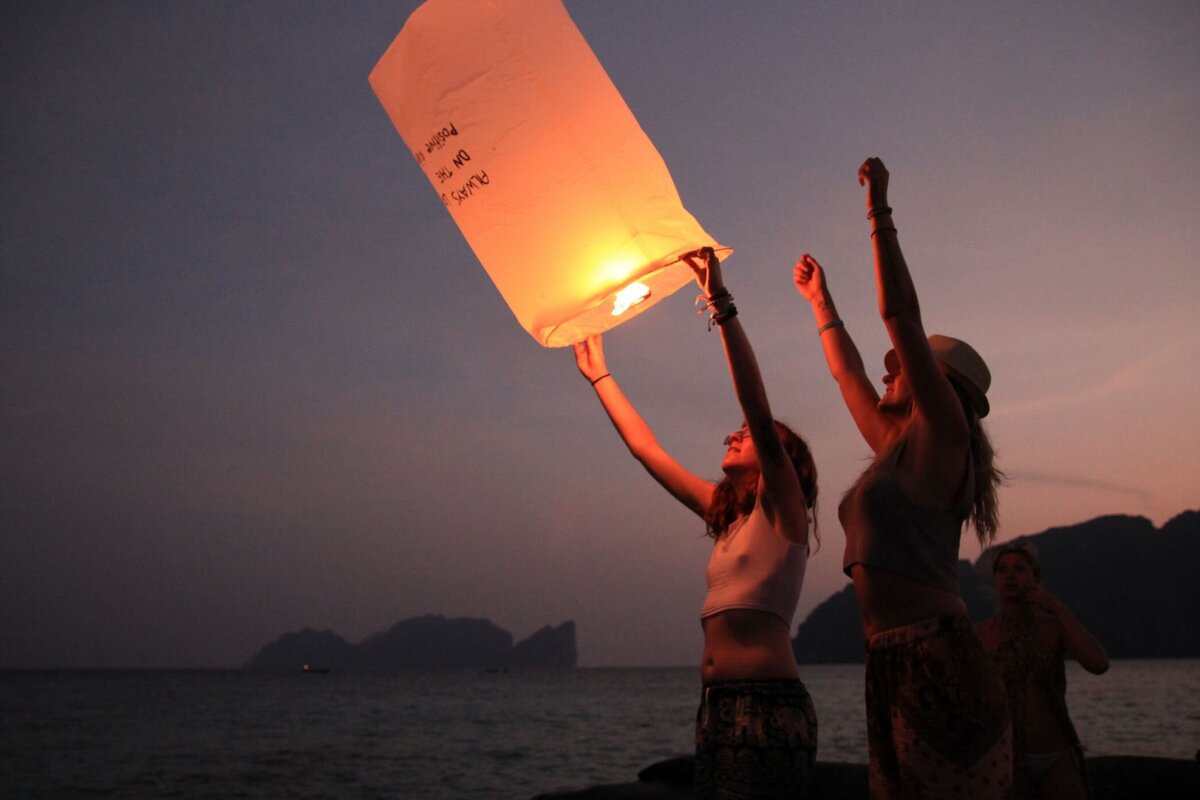 yoga teacher and student during a lantern ceremony