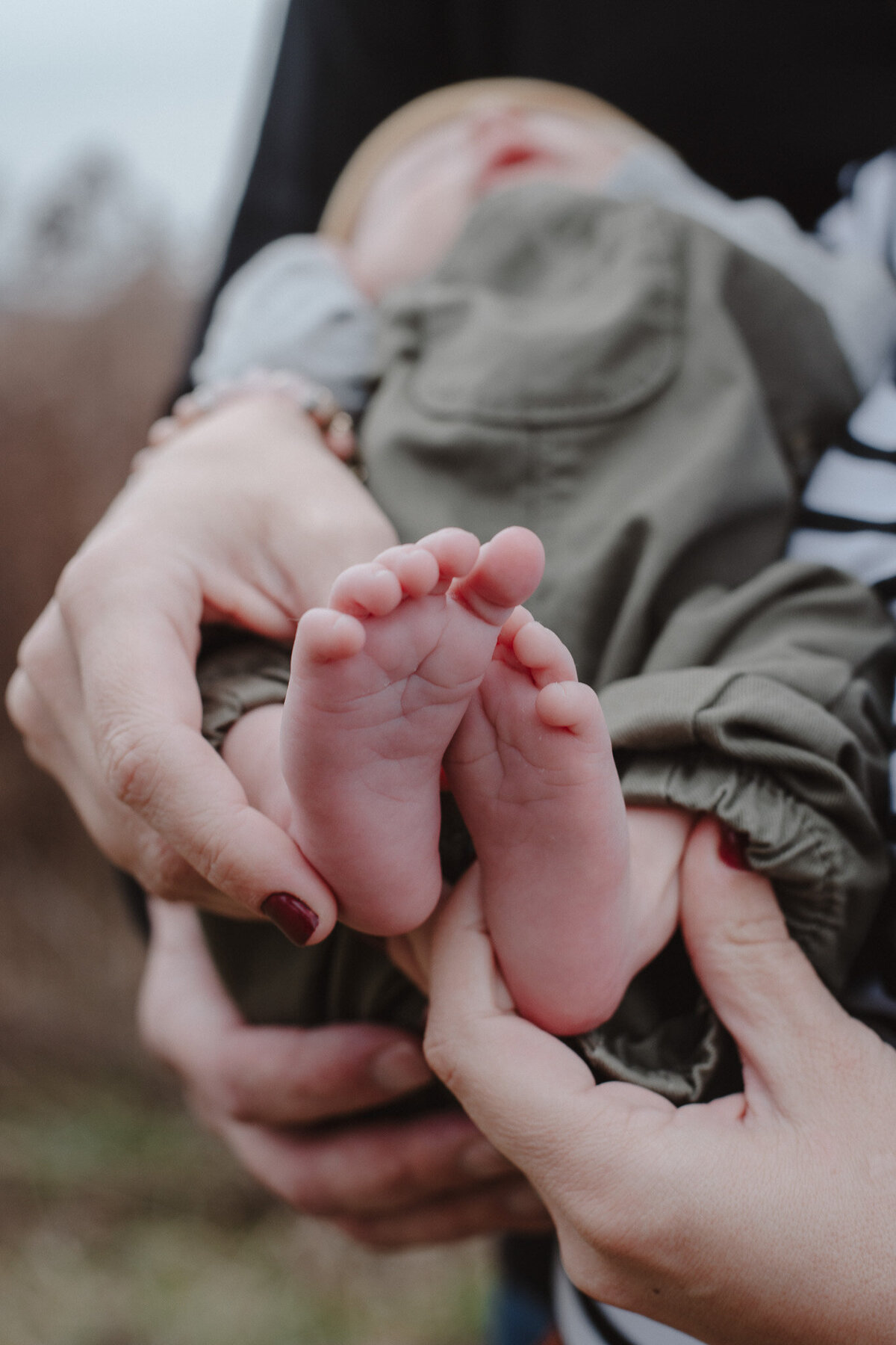 A heartwarming moment as a baby is lovingly held by their parents in a peaceful park in Northeast Ohio. Surrounded by the natural beauty of the park, this intimate family portrait captures the deep bond and affection between the parents and their child. Perfect for families seeking timeless, nature-inspired baby and family portraits in Cleveland and beyond.