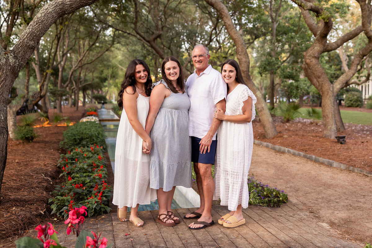 father and his three grown daughters at Cerulean Park inside watercolor, Florida on 30a.