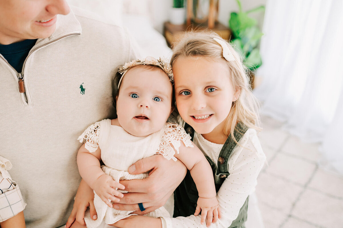 Springfield MO family photographer captures sisters cuddling in photo studio