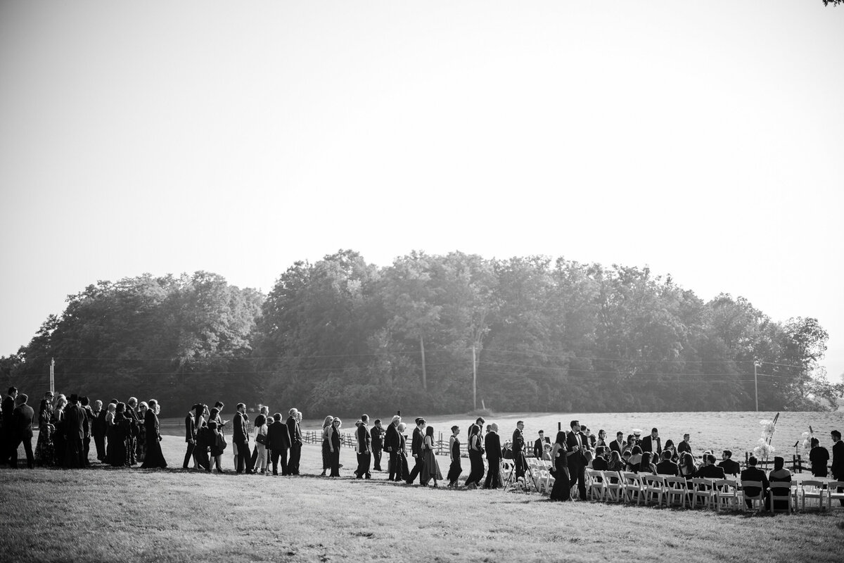 Guests walk to a ceremony at a destination wedding in Vermont