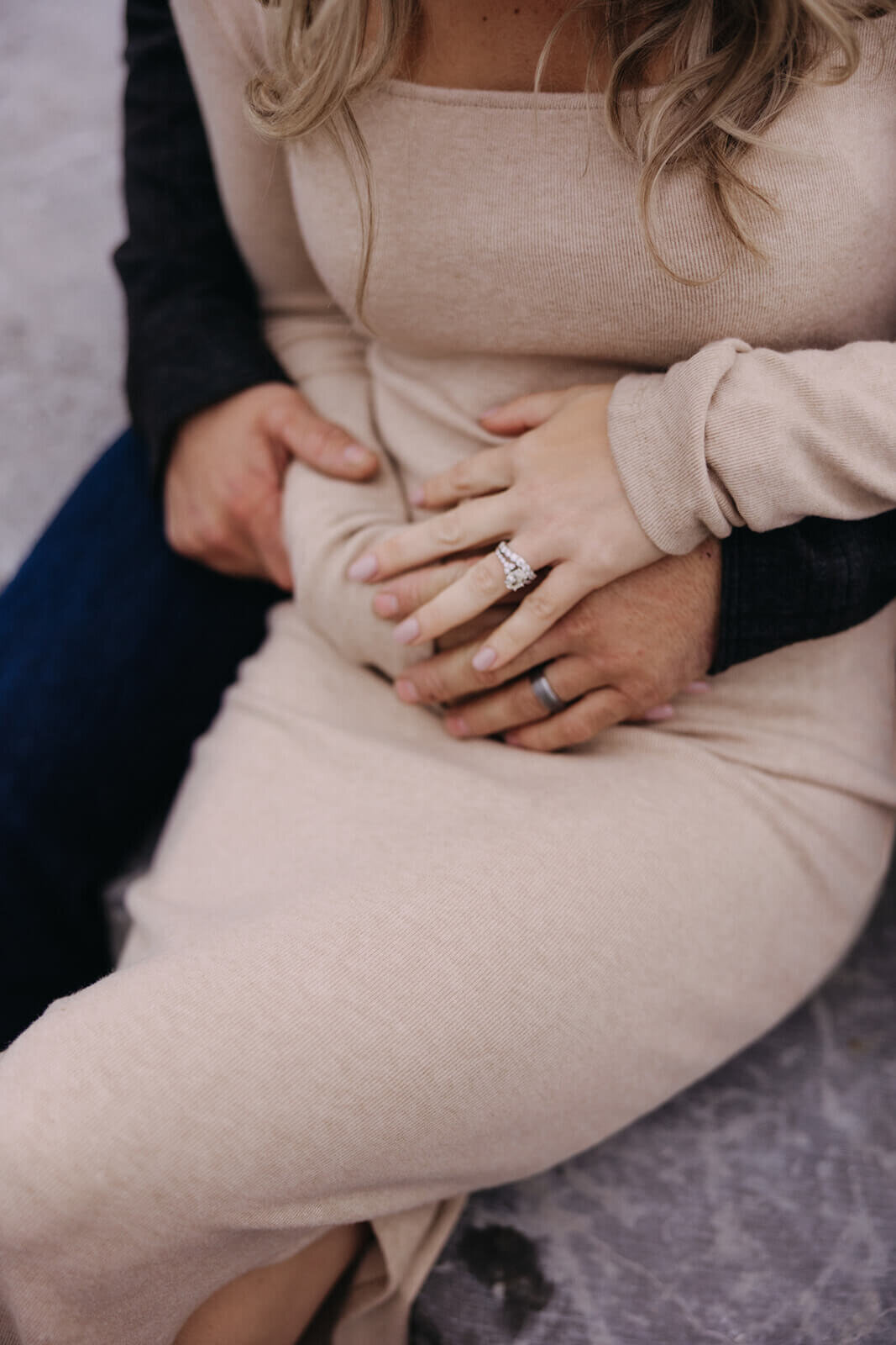 Couple with arms wrapped around each other for at Finger Lakes maternity session