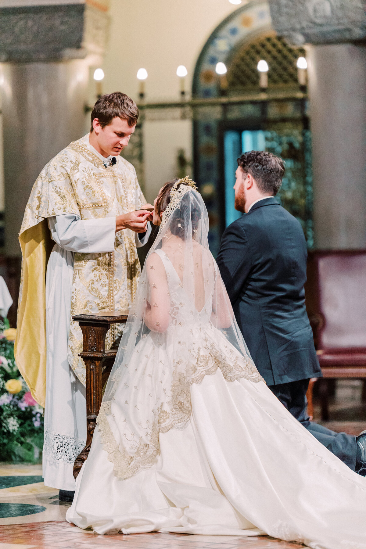 Bride and groom taking Eucharist at St Monica St George wedding in Cincinnati