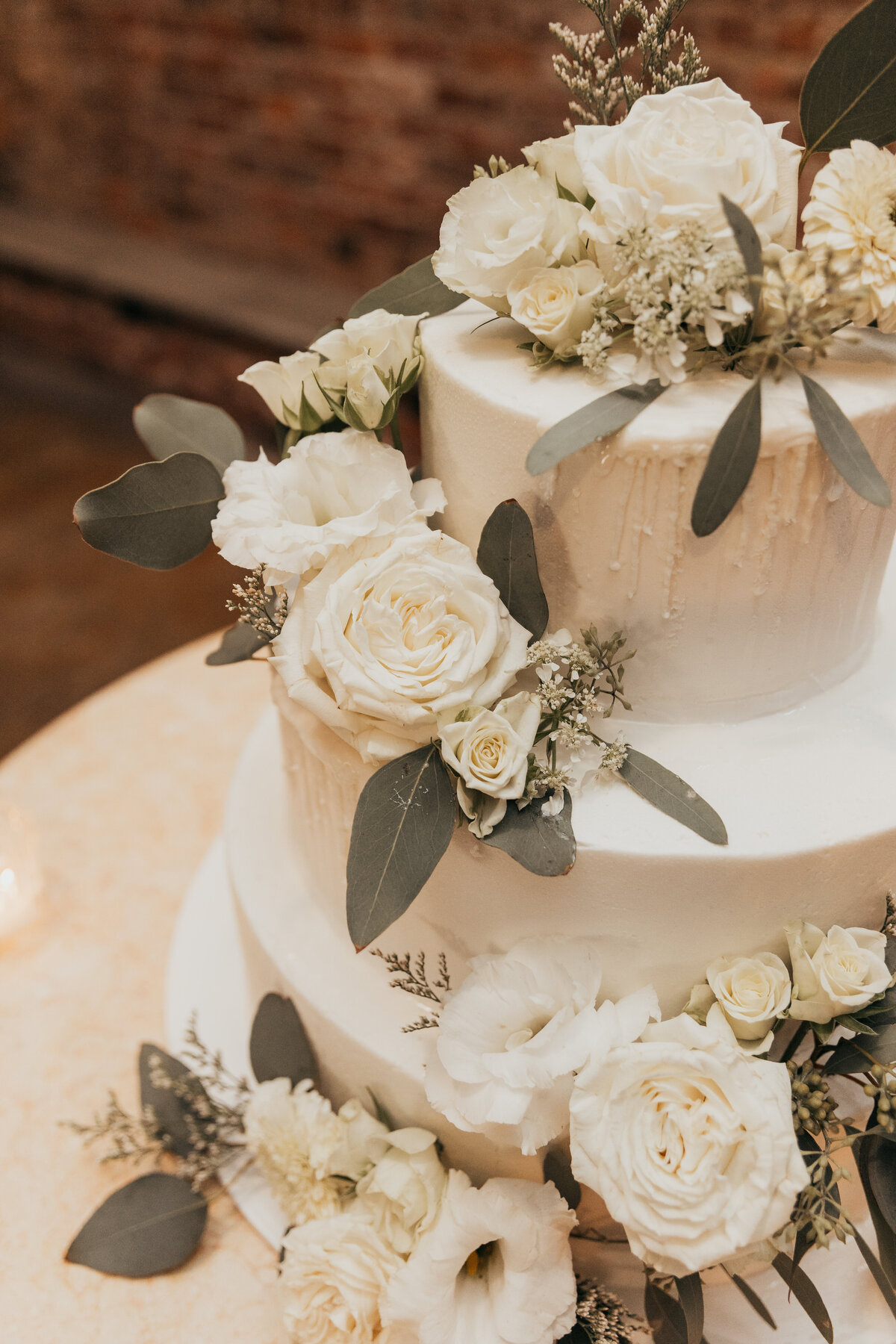 Such a beautiful three tiered cake with all white roses. 