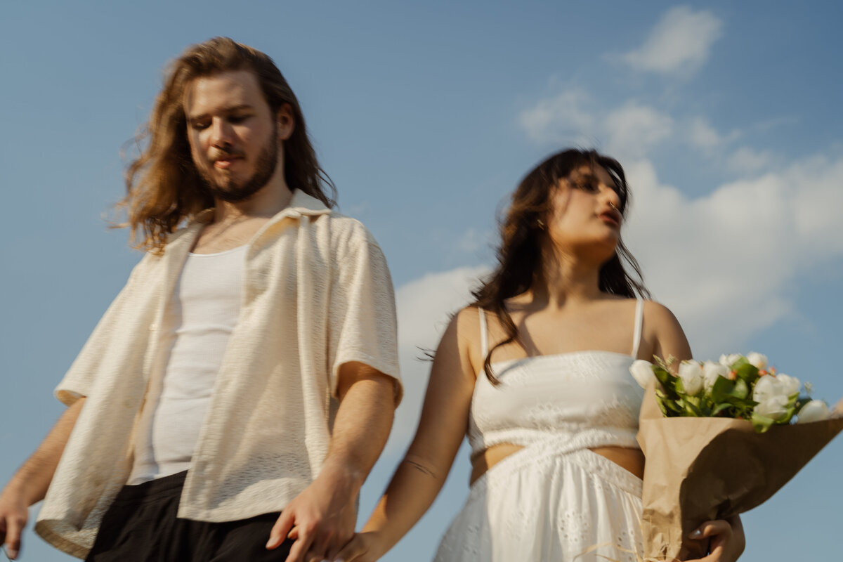A photo of the couple standing together with a bouquet, symbolizing unity and love in the park near White Rock Lake.A photo of the couple standing together with a bouquet, symbolizing unity and love in the park near White Rock Lake.