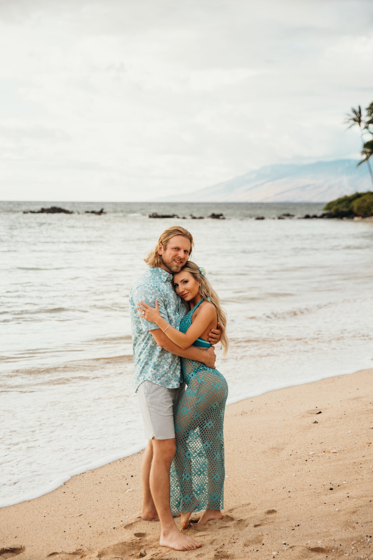 Hawaii Engagement Photographer captures woman hugging man on beach