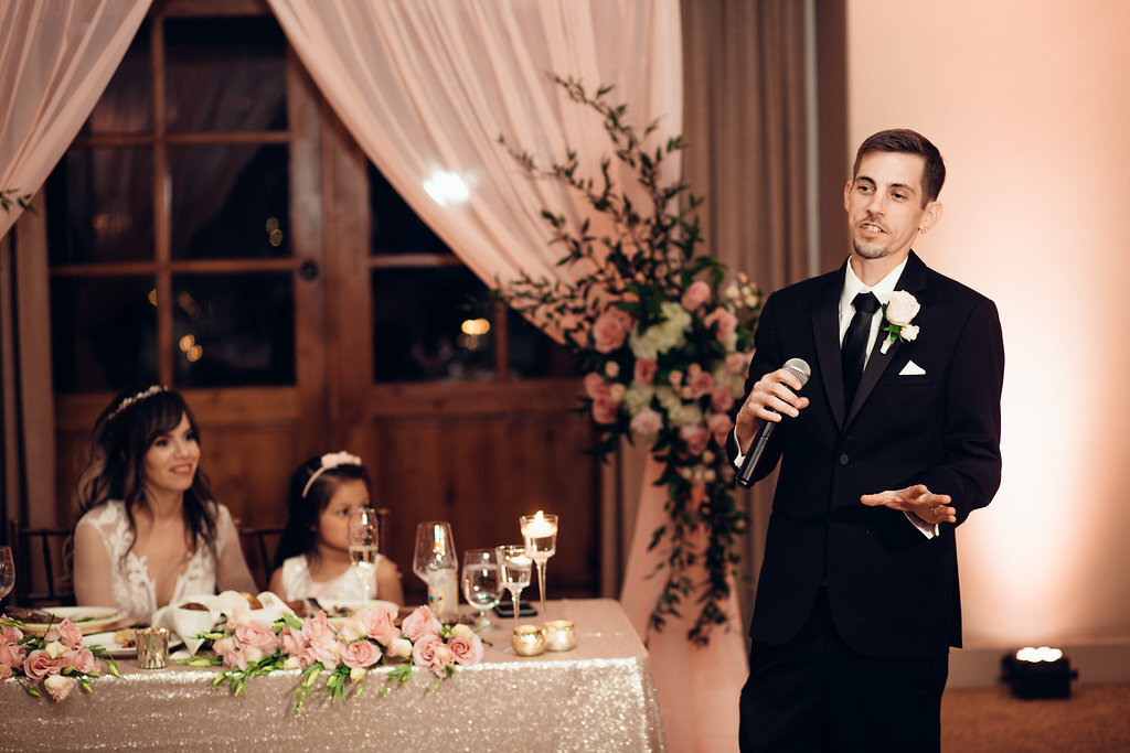 Wedding Photograph Of Bride And Child Looking At The Groom Speaking In The Microphone Los Angeles