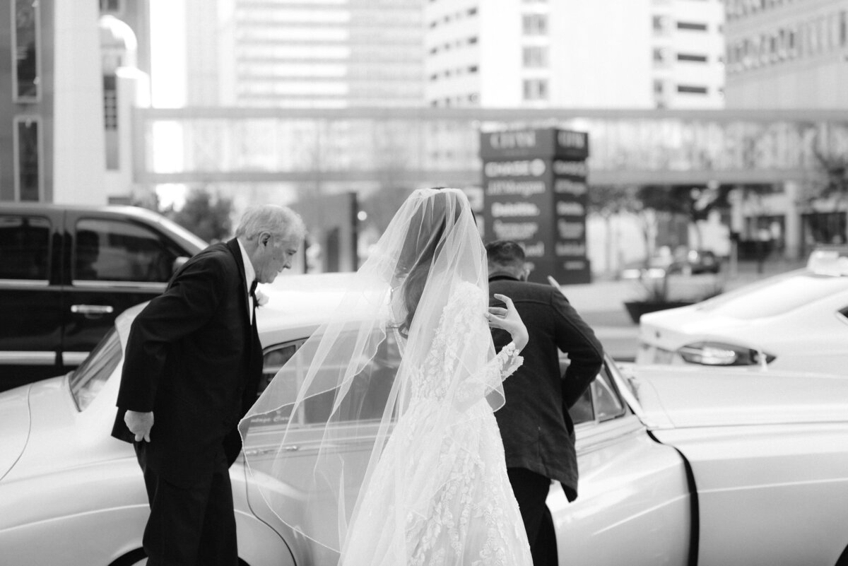 bride looking at her dress on wedding day