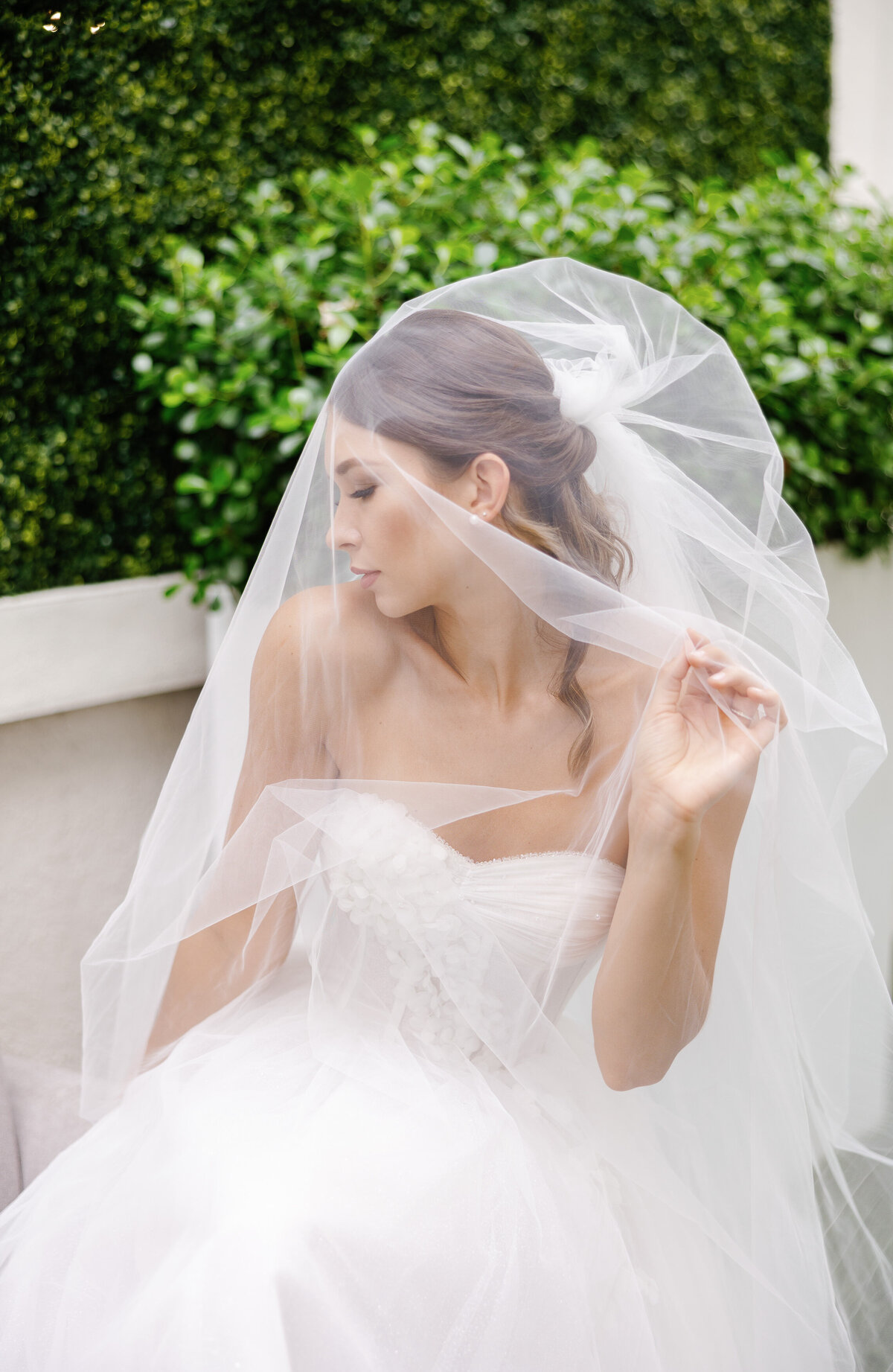 Color portrait of a bride under a veil, captured by Miami wedding photographer Claudia Amalia, highlighting her detailed wedding photography.