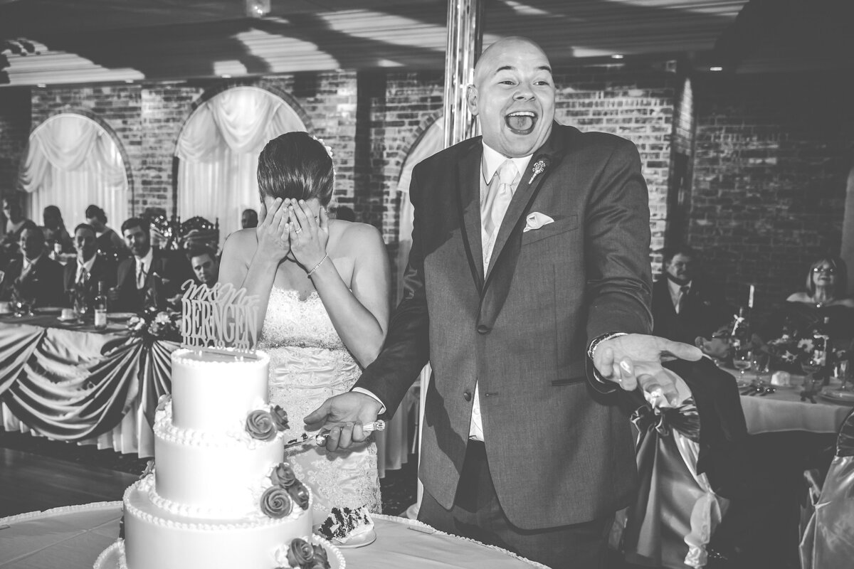 A bride and groom cut the cake at their wedding.