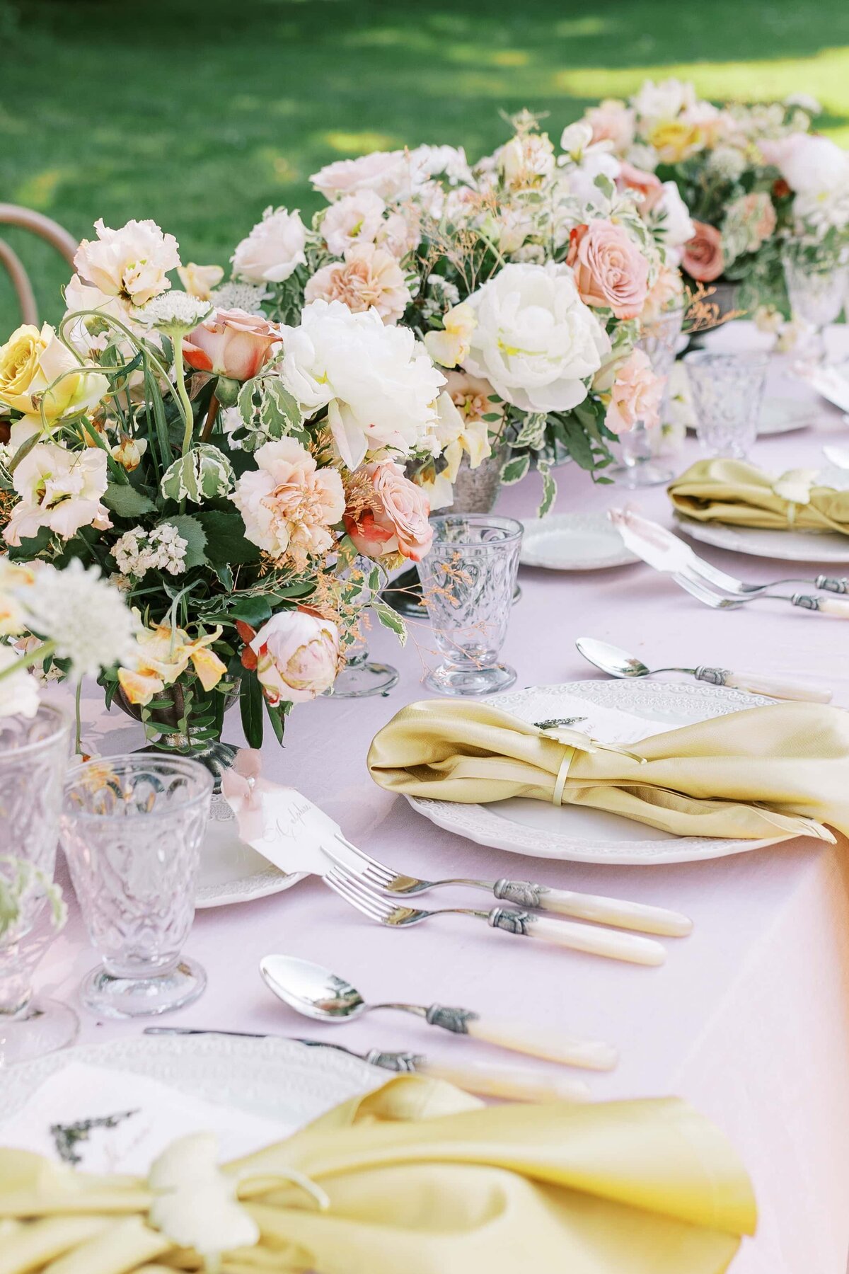 Yellow table setting with white flower bouquet