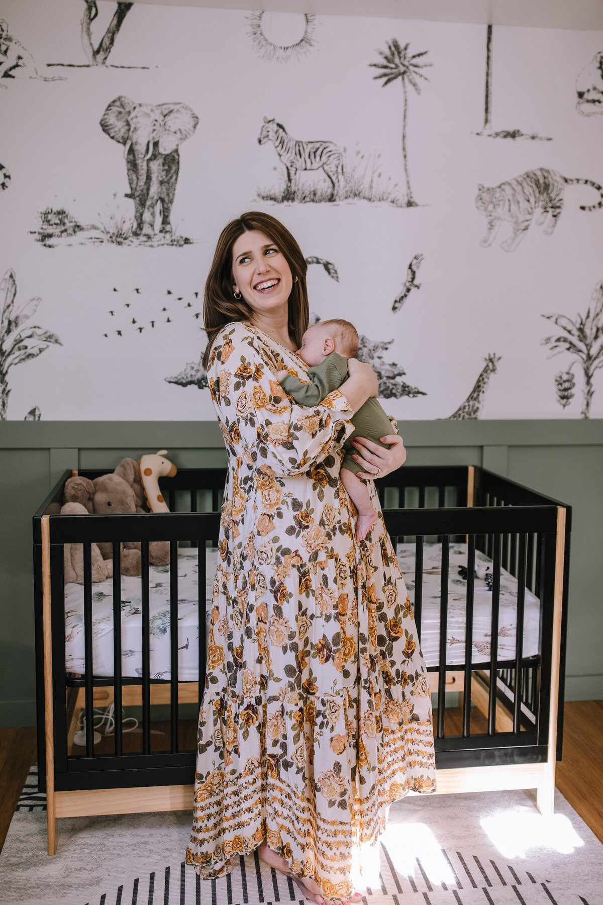 Mom in a nursery with her newborn in Pittsburgh. 