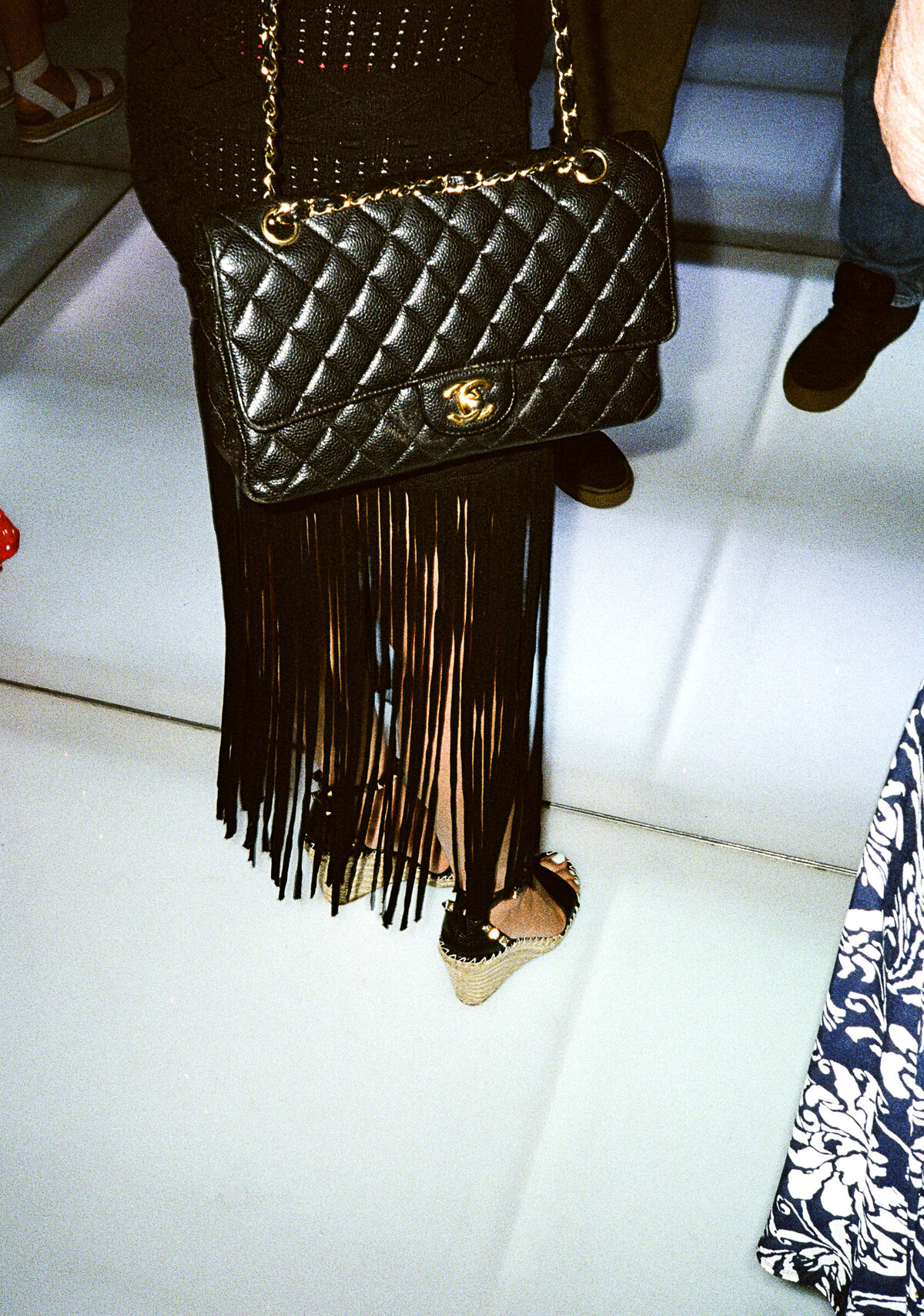 Photo of black fringe dress and black Chanel bag on film in private backyard party by Mira Park Photography NY based wedding photographer