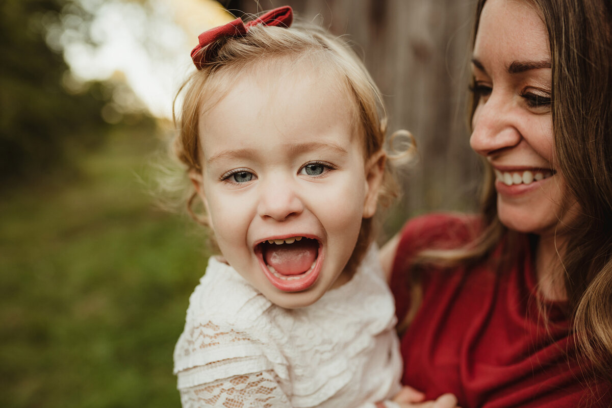 A mother is amused at her daughter's silly expression.