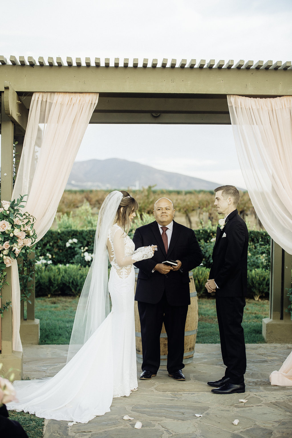 Wedding Photograph Of Two Men in Black Suit Looking at The Bride Los Angeles