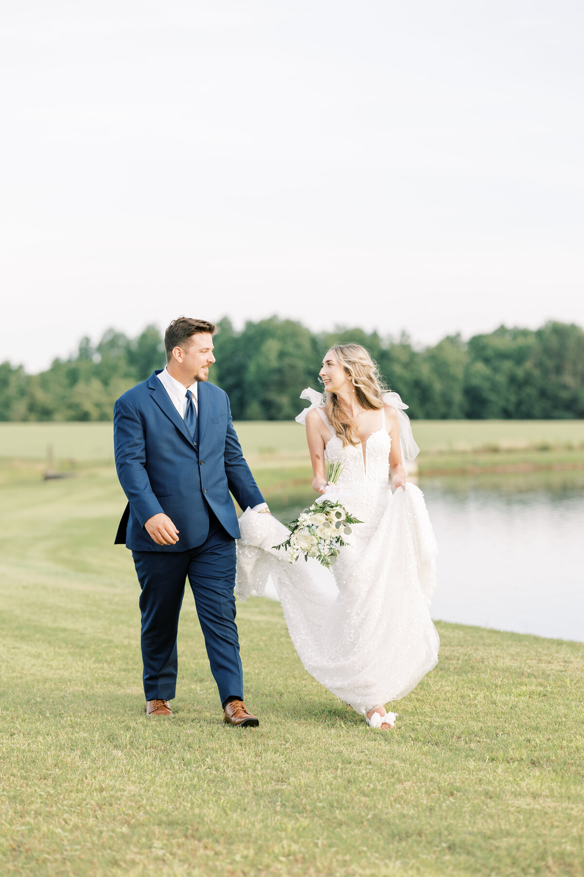 bride and groom walking together at Under the Oaks Venue