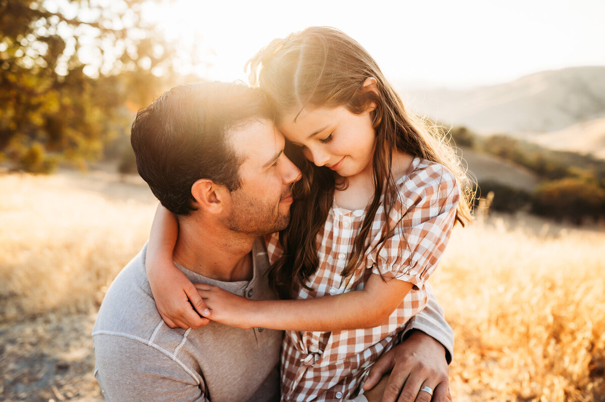 Father and daughter sharing an embrace in the Livermore Hillside