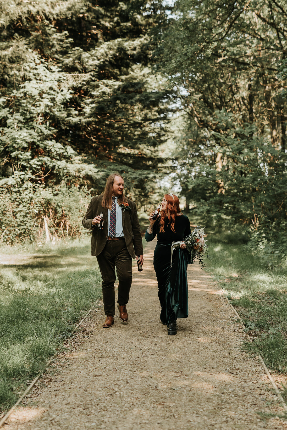 Relaxed Bride & Groom walking through the woods at Two Woods Estate