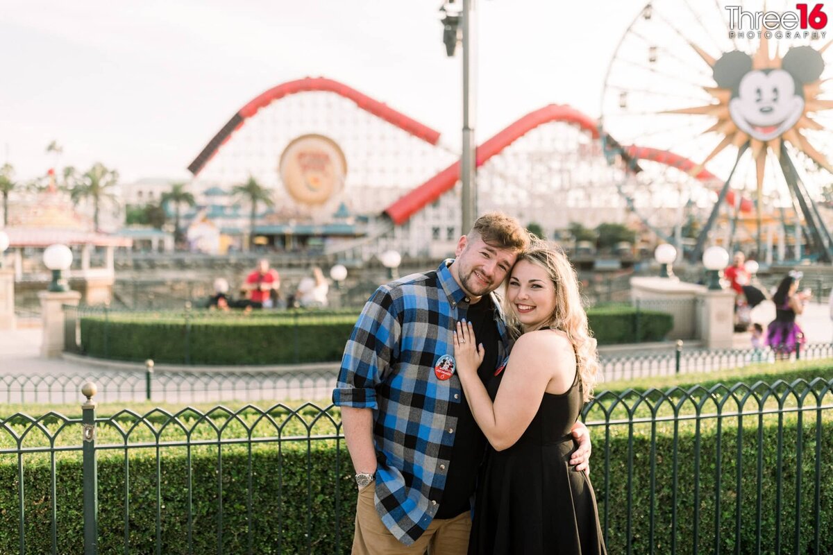 Disneyland California Adventure engagement session as the couple cozies up to each other.