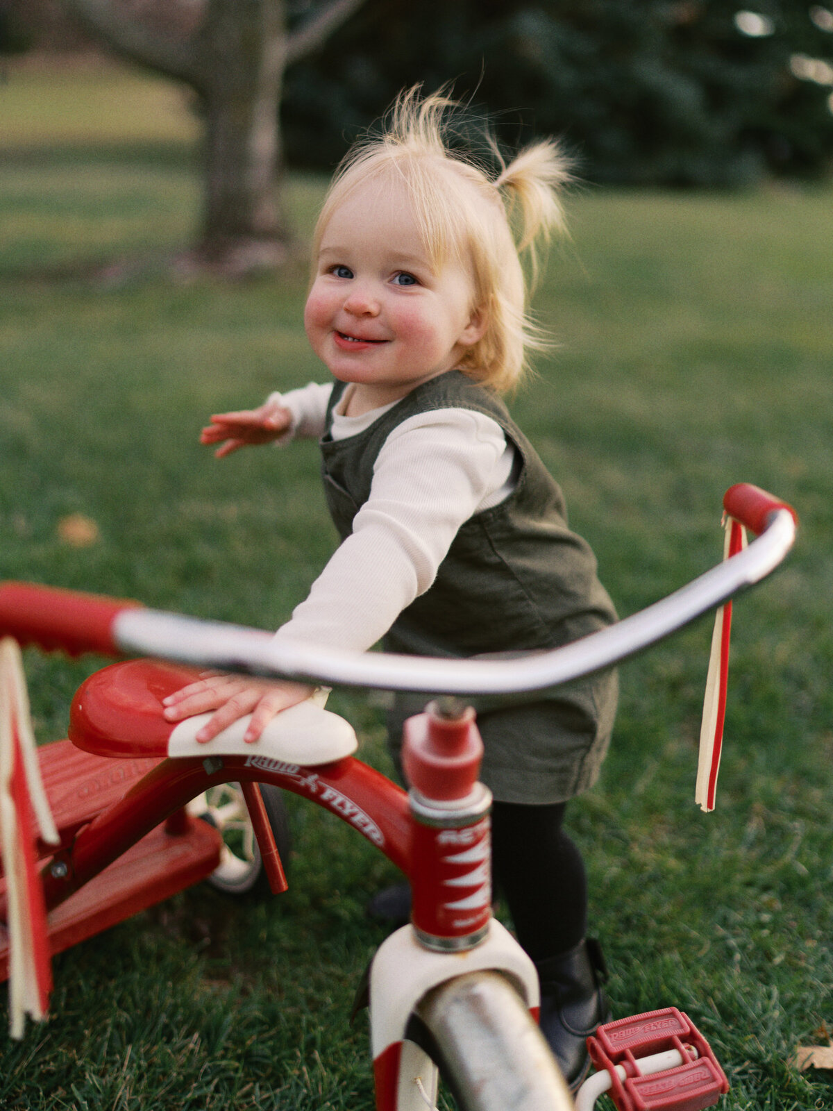 baby-climbing-on-radio-flyer-bike