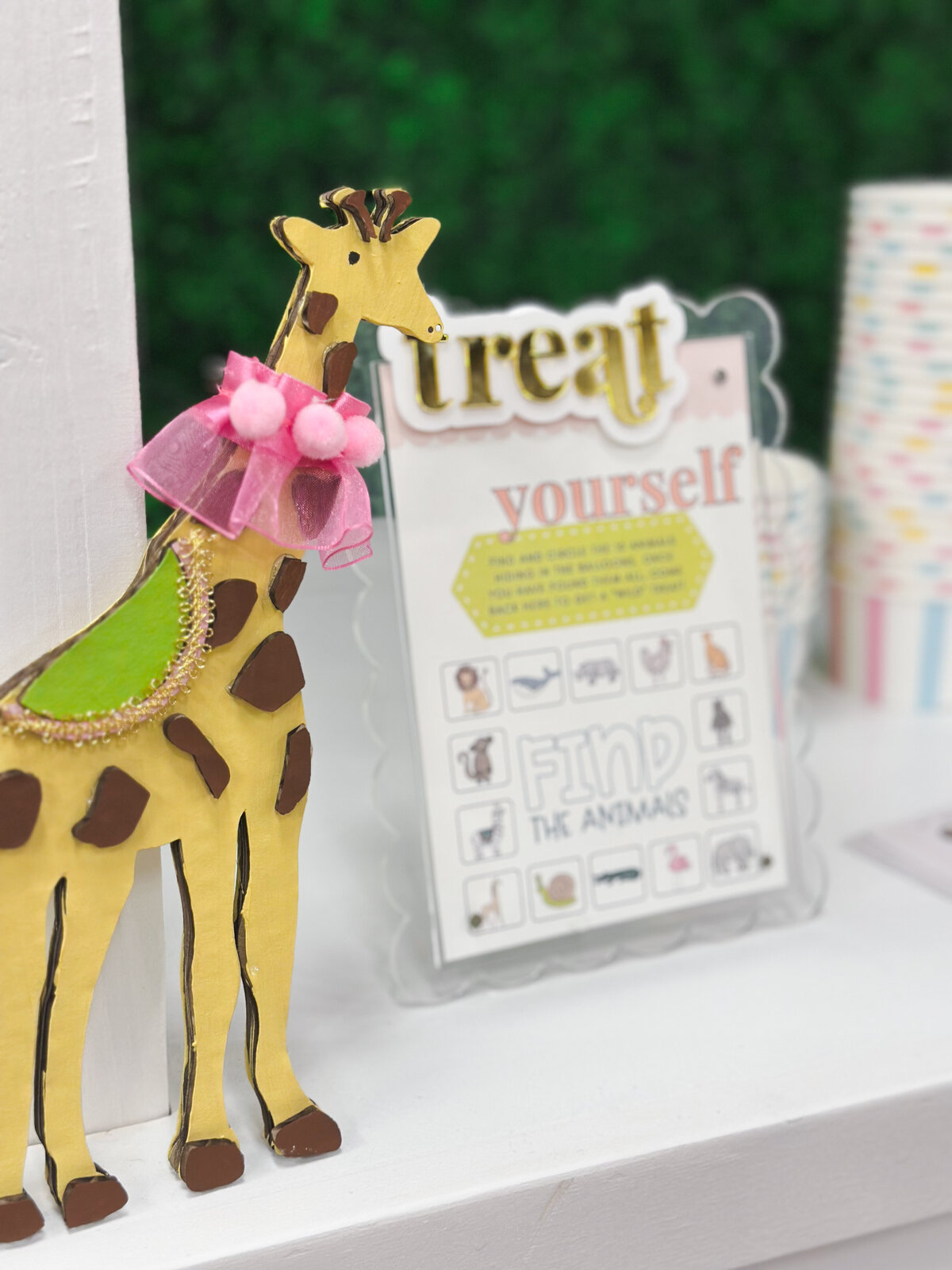 Acrylic custom sign with giraffe cutout on a dessert cart. 
