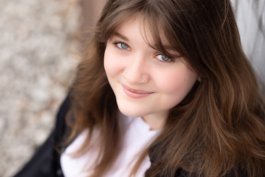 High school senior looking up and smiling.