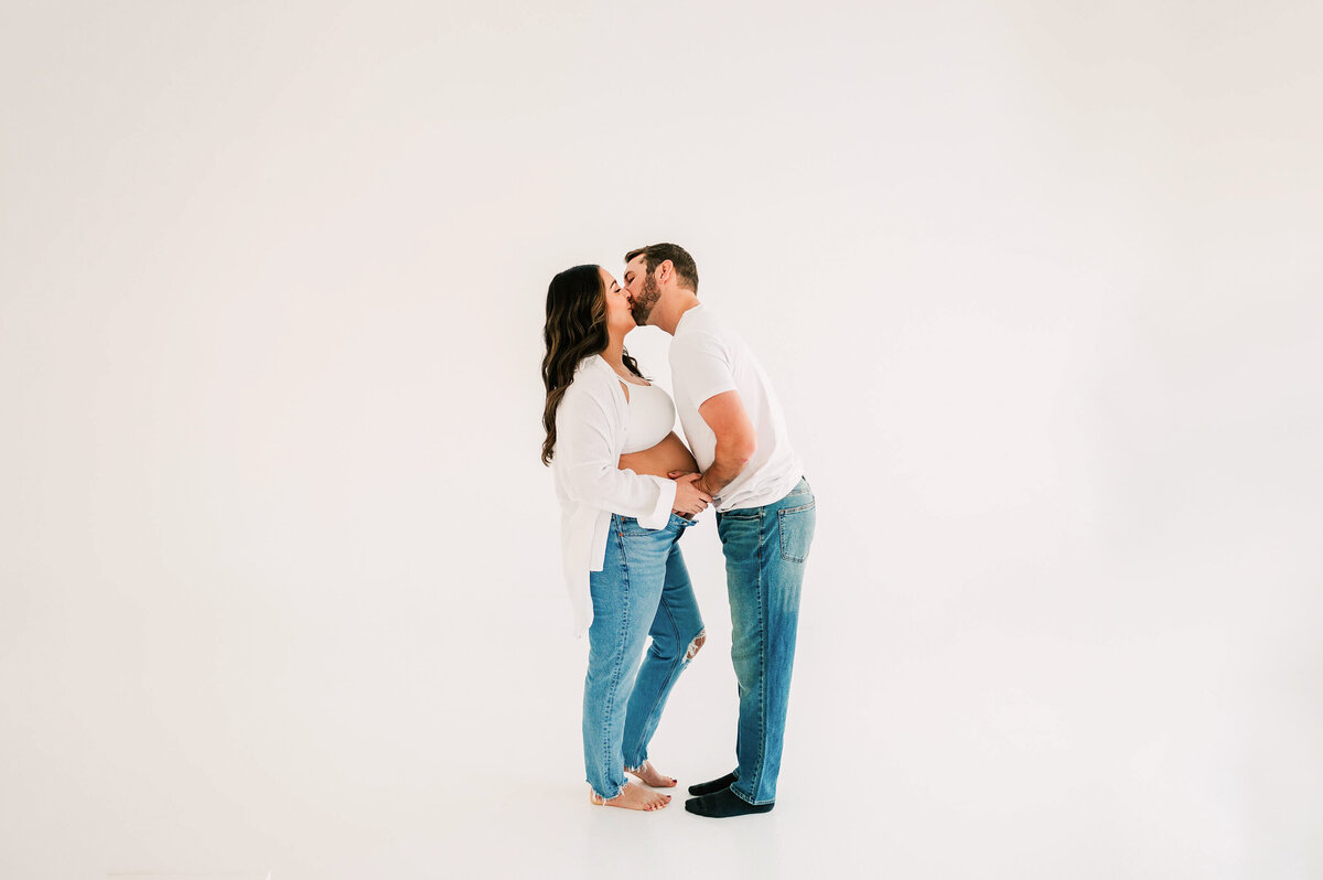 pregnant couple kissing in maternity photography studio in Springfield MO