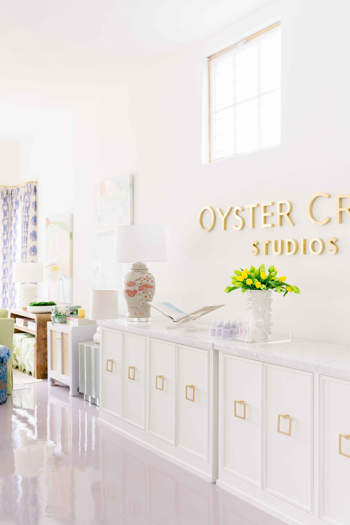 oyster creek studios office gold logo wall white console