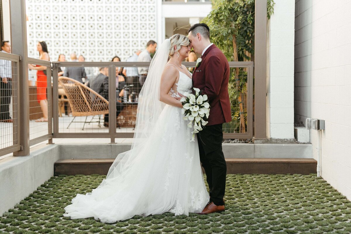 a husband and wife share a tender moment in the Hart and Main Courtyard