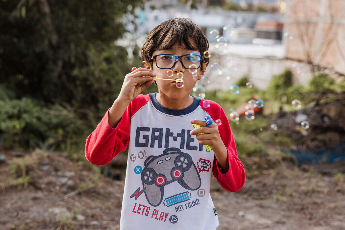 Young boy blowing bubbles in Ecuador during VBS camo