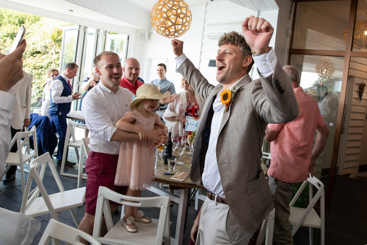 Grooms entry to wedding breakfast at Tunnels Beaches in Devon